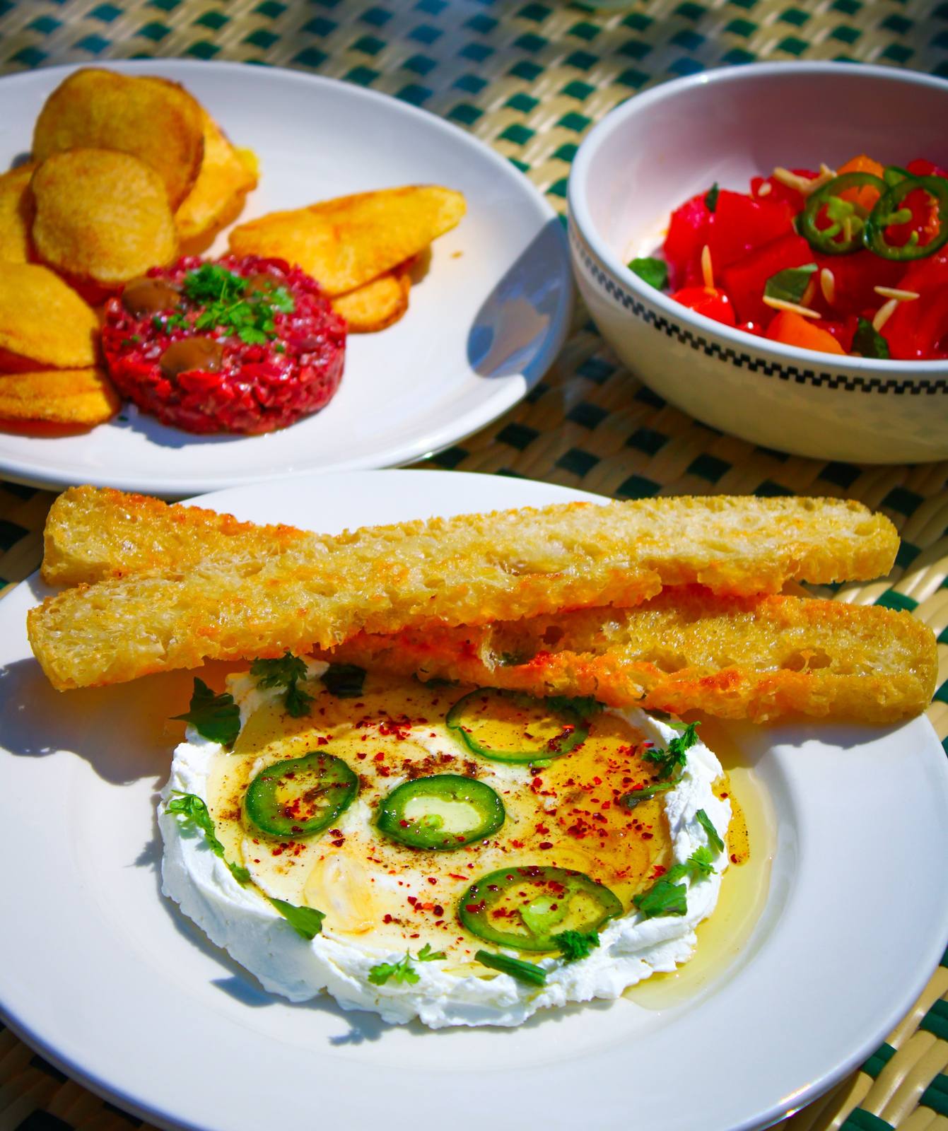 Whipped feta with jalapeño and grilled bread, beef tartare and a tomato salad at The Chloe